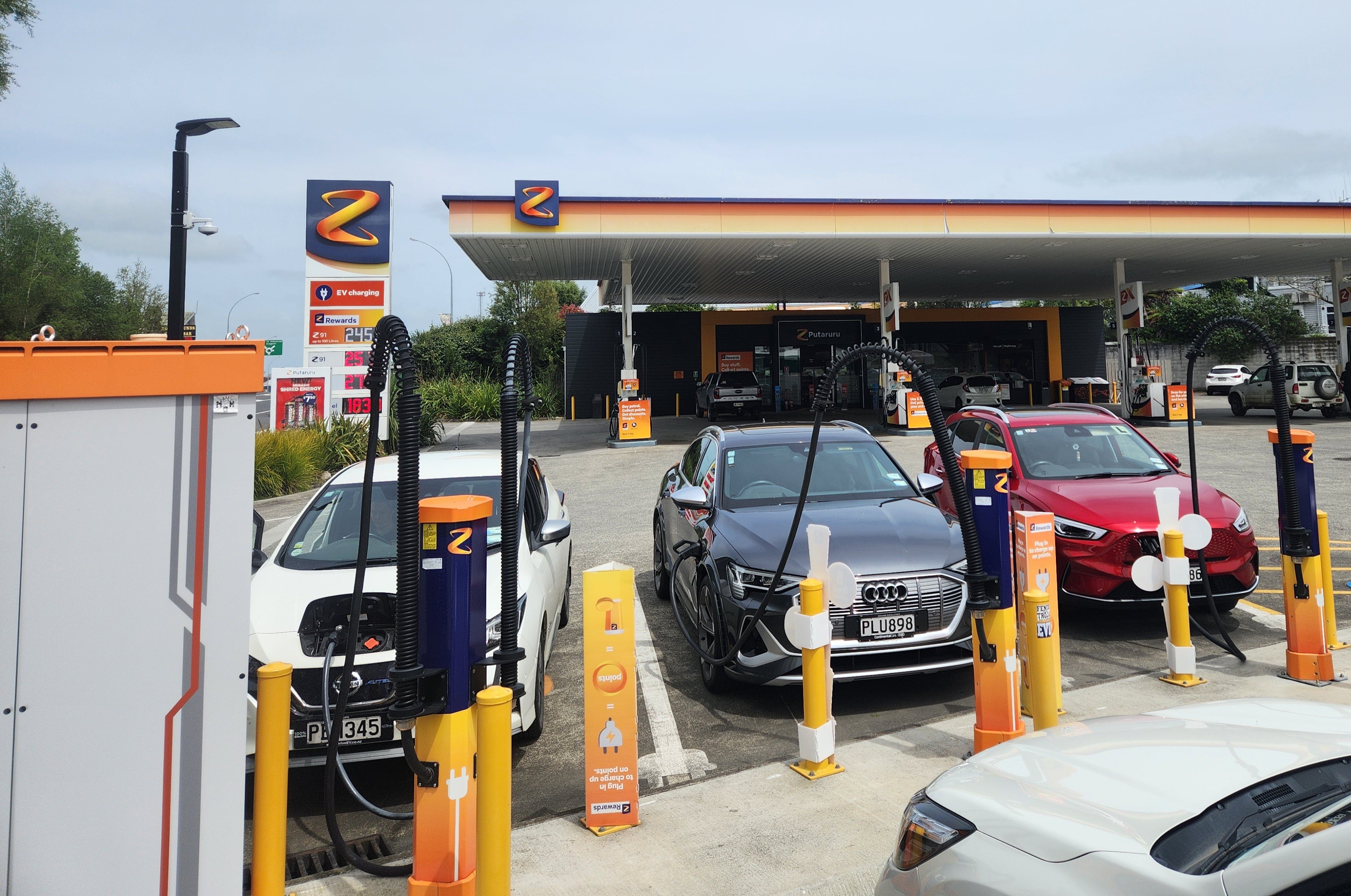 Photo of three cars on chargers and only one at the petrol pump at the Z station in Putaruru