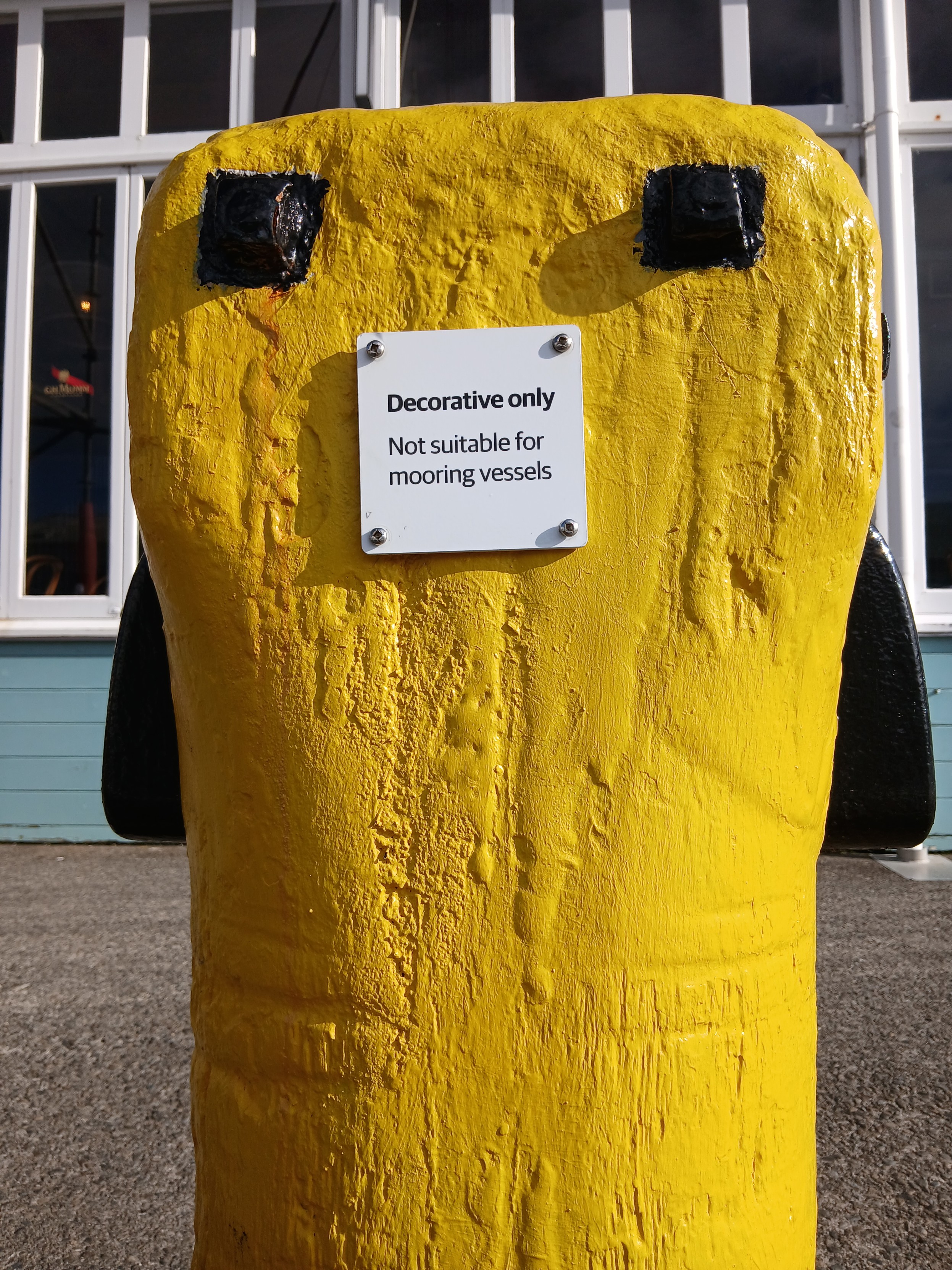 A label attached to the side of bright yellow bollard in thd previous pic. It reads: decorative only. Not suitable for mooring vessels.